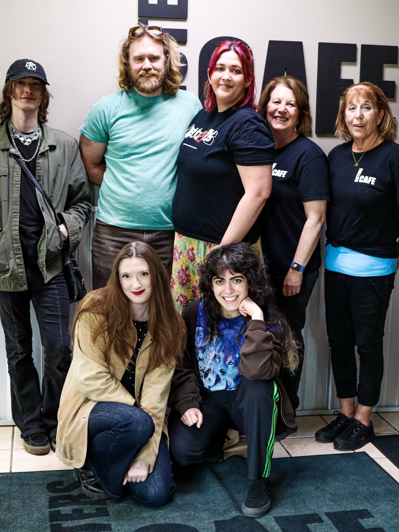 Cast and crew gathered at Sisters Cafe during filming